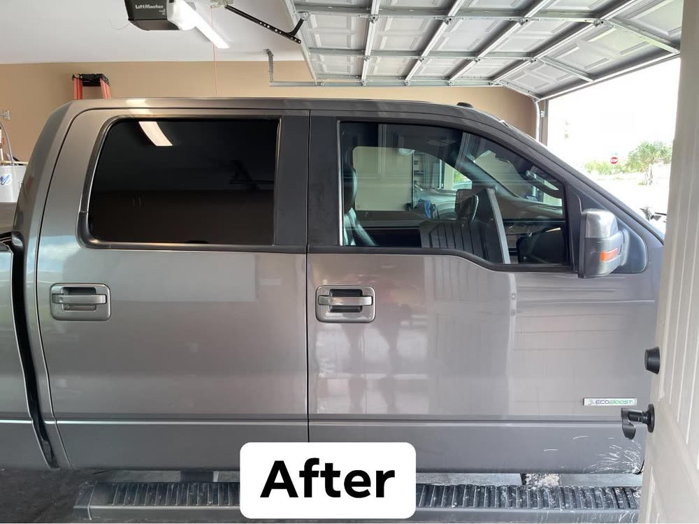 The same side of the same truck after tinting — the rear door glass is fully blacked out and the front is deeply shaded
