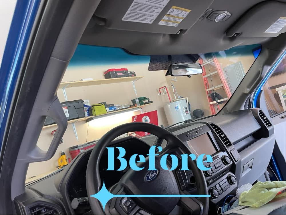 Looking out through the windshield of a blue Ford F-150 before tinting
